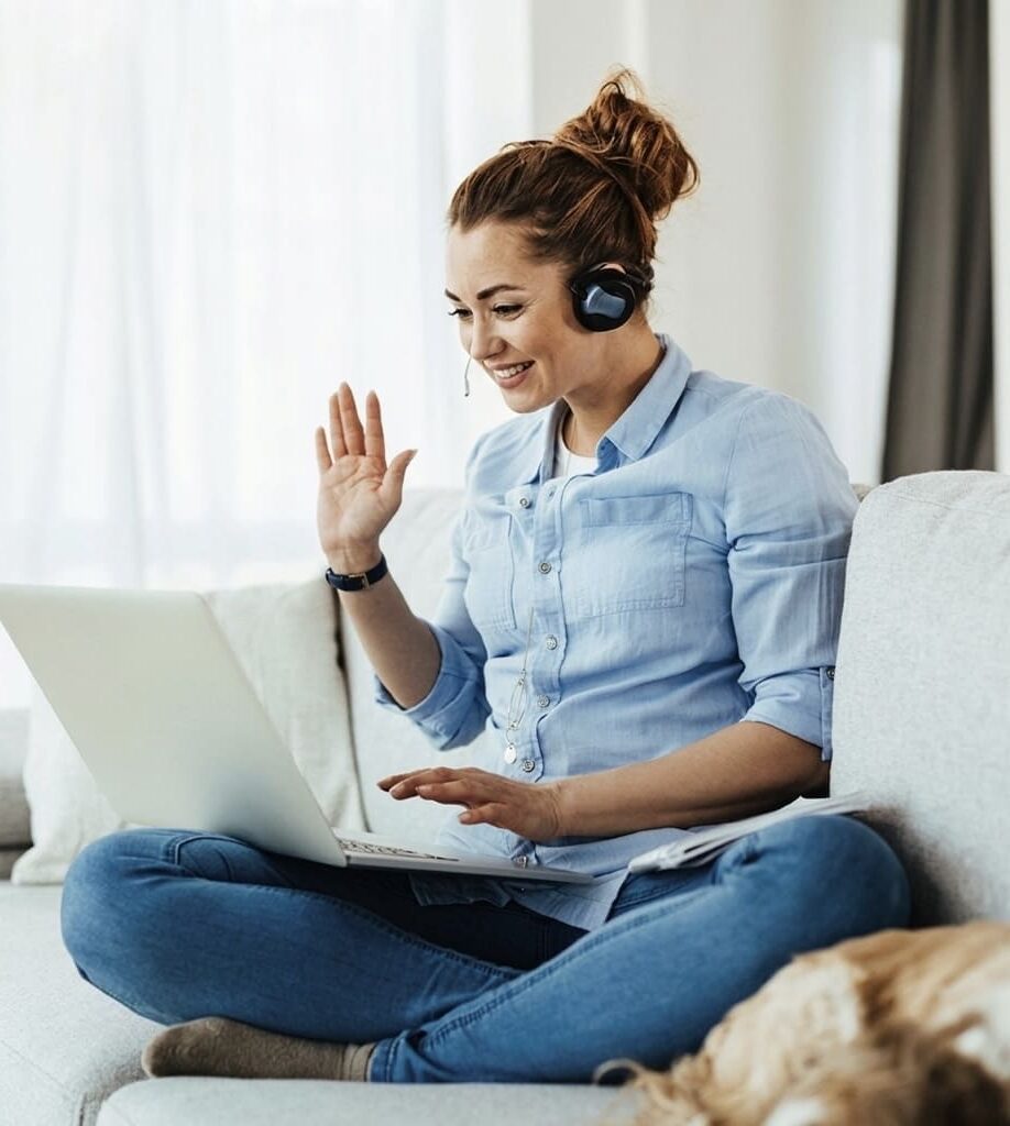 Woman attending an online consultation with a headset and laptop - LeaveConsult